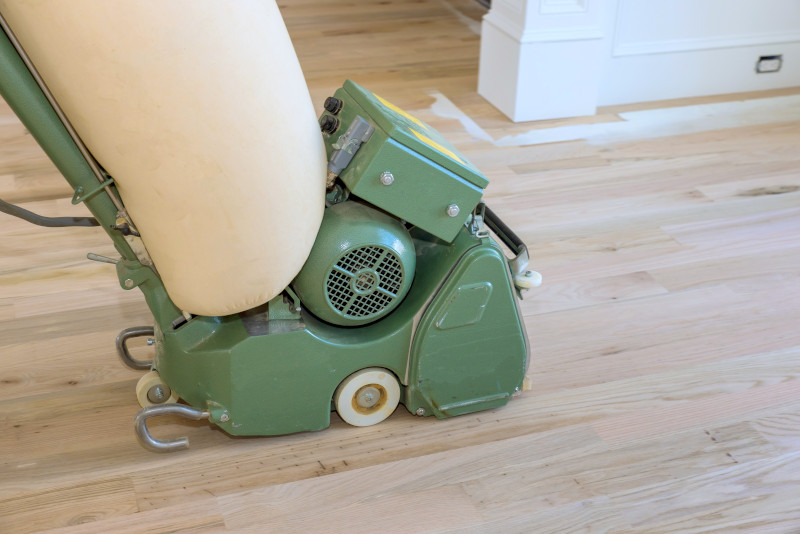 close up of machine sanding a wooden floor